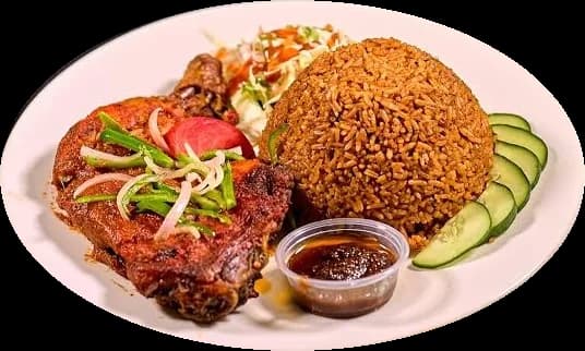 Jollof rice with grilled chicken, salad, cucumber and shito on a white plate